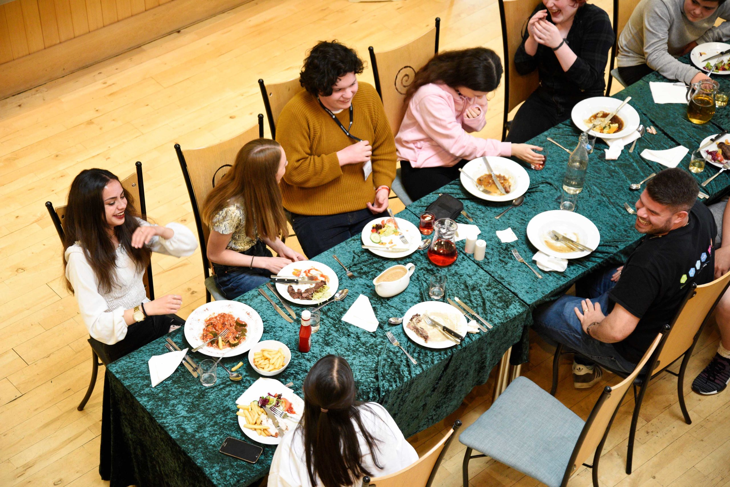 People having dinner around a long table