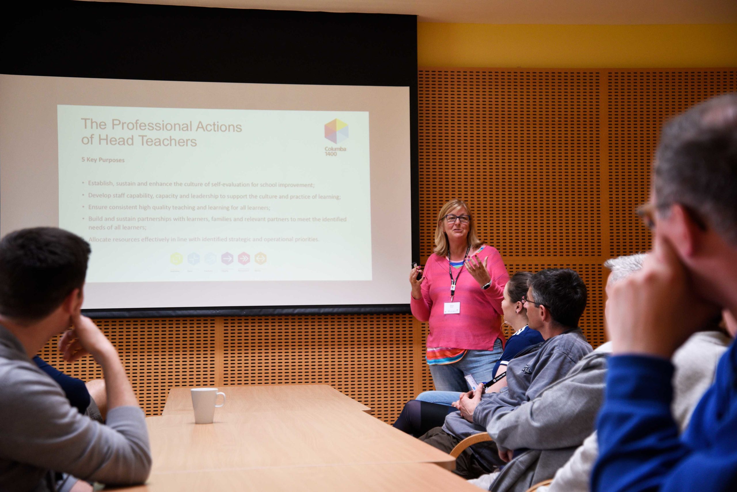 Woman giving presentation on 'The Professional Actions of Head Teachers'