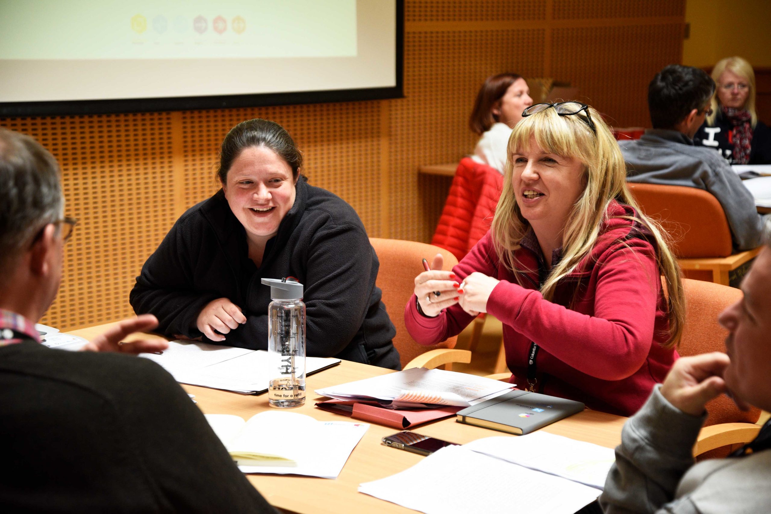 Group in happy discussion around a table