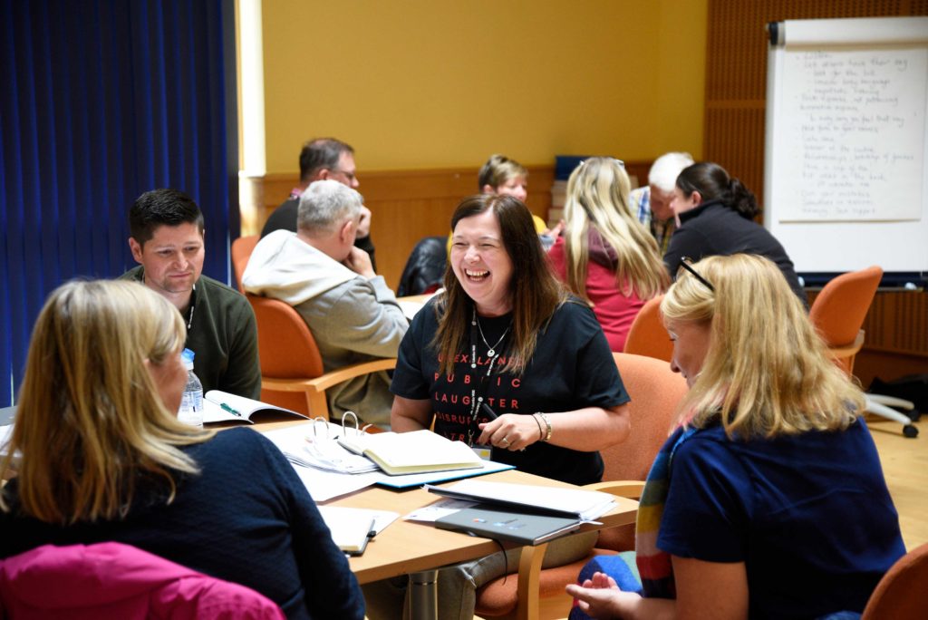 Group laughing around a table