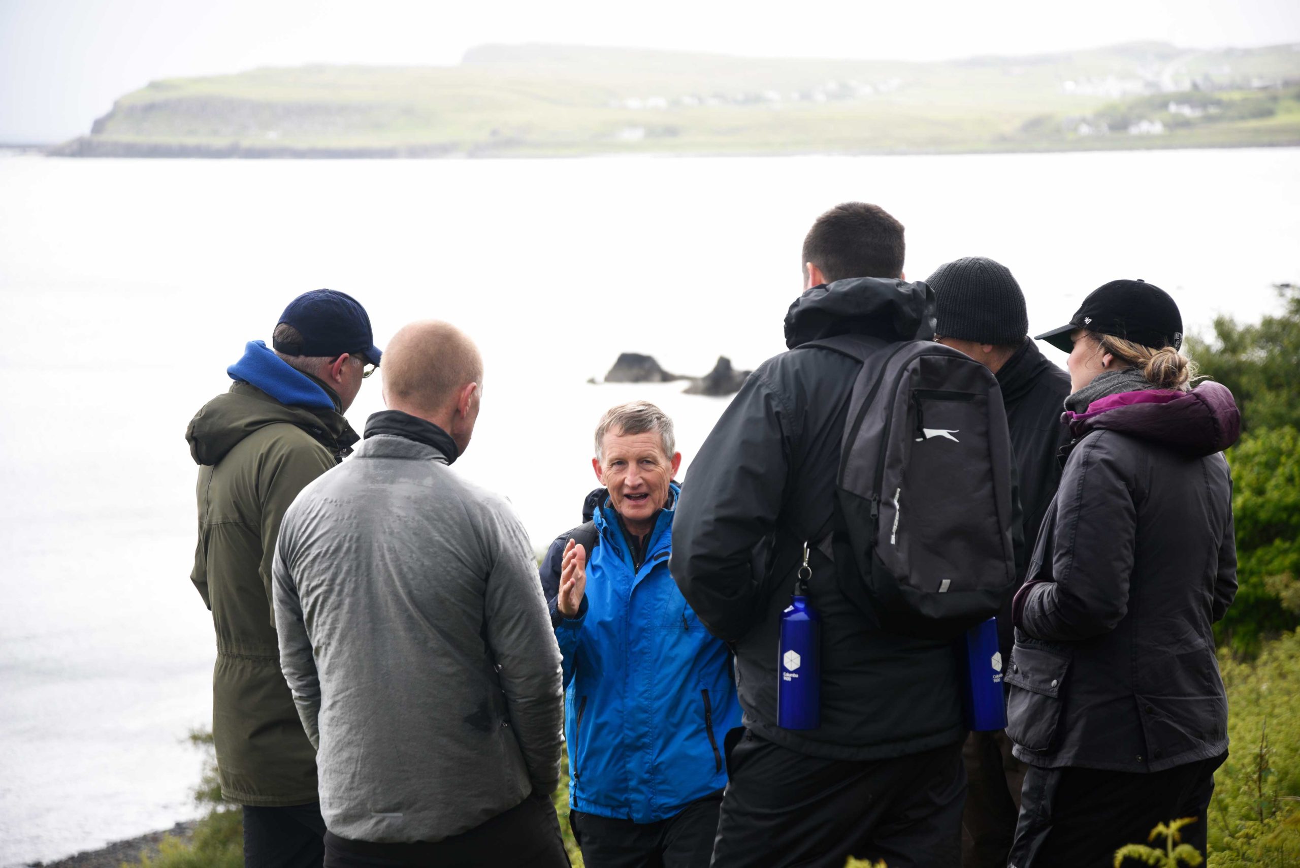 Group listening to an instructor talk outside on Skye